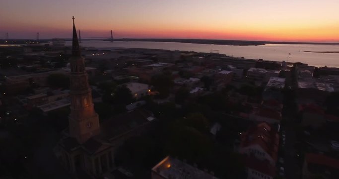 Aerial Rotating Silhouette of Saint Phillip Church and Ravenel Bridge in Charleston