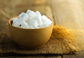 white sugar in a wooden bowl