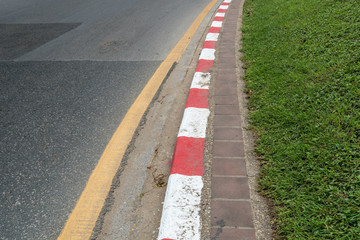 Red and white concrete road curb