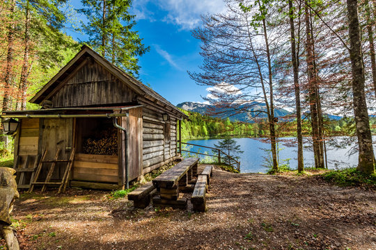 Forest Wooden Hut In The Alps At The Lake