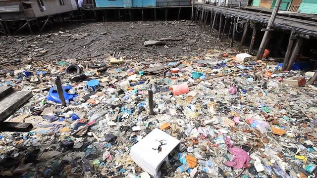 Plastic pollution problem, Plastic bags and bottles dumped into sea causing environmental damage,