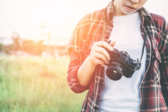 beautiful women photography hand holding retro camera in the par