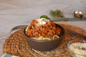 Spaghetti bolognese with meat tomato sauce and parmesan on a bowl