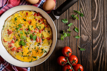 Traditional Frittata with potato, cheese, bell pepper and herbs