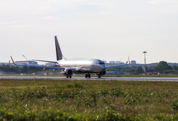 Fototapeta premium Big white passenger jet plane on runway at the airport