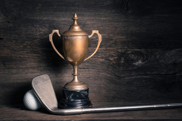 old trophy with golf club