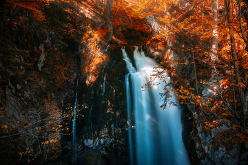 waterfall in autumn with sunshine