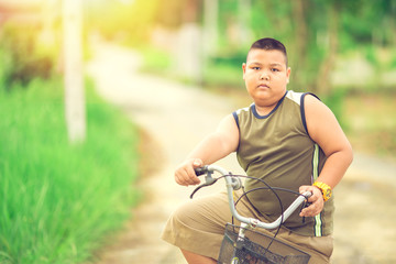 Obraz premium Bicycle is a good exercise for fat children to decrease the overweight or obese.