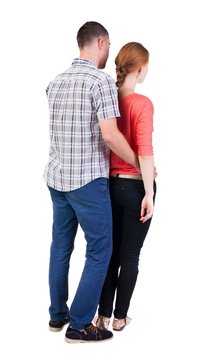 Back view of young embracing couple (man and woman) hug and look into the distance. beautiful friendly girl and guy together. Rear view people collection.  backside view of person.  Isolated over