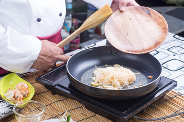 Chef stitr fried rice noodle for cooking Pad Thai