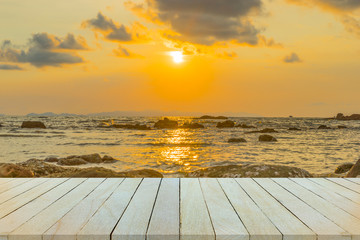 Empty wooden table or shelf wall with  sunset or sunrise on sand