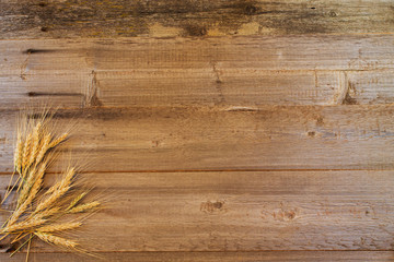ears of wheat on the wooden background