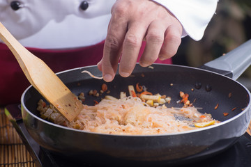 Chef stitr fried rice noodle for cooking Pad Thai