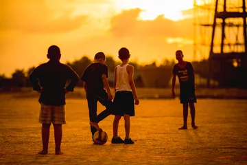 Poster boys are playing football in the sunshine day. © nateejindakum