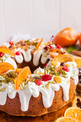 Closeup of bundt cake with shugar icing and fruit