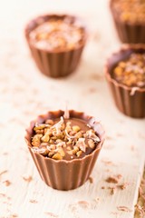 Few chocolate cupcakes with nuts and sweet shavings