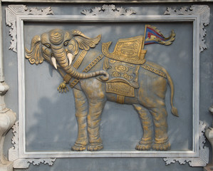 Ancient bas-relief from a sacred elephant at the entrance to the main temple of the Snake village (Le Mat)