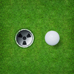 Golf ball and golf hole on green grass of golf course.