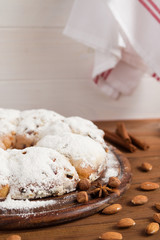 Christmas stollen and spices on wooden background