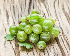 Gooseberries on the wooden table.