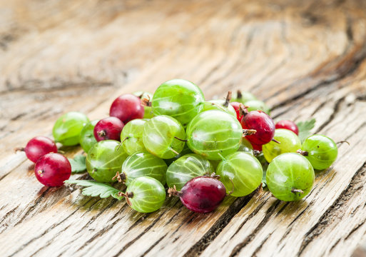 Gooseberries on the wooden table.