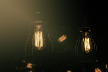 Edison bulb glowing in the dark blurred background