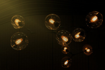 Edison bulb glowing in the dark blurred background