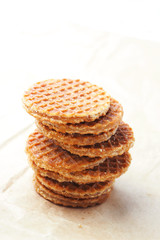 Close up of stack of Dutch caramel waffles on a waxed paper.