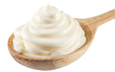 Mayonnaise swirl in the wooden spoon. File contains clipping pat
