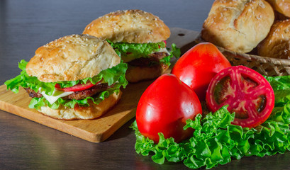 Close-up of home made tasty burgers on wooden table