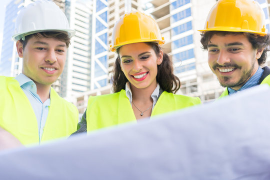 Architects with ground plot on construction site