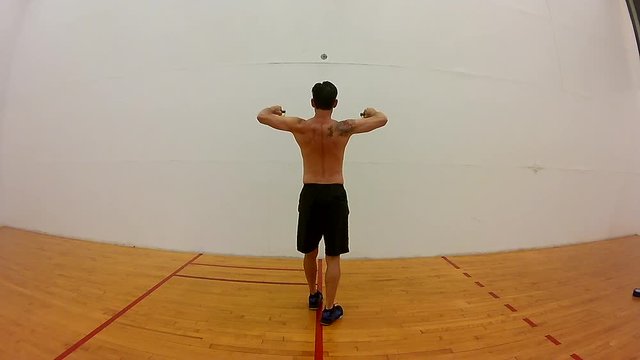 Shirtless Japanese Middle Age Man Resistance Band Exercise Rotator Cuff From Rear View.