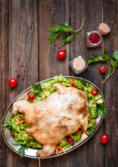 Served split roasted stuffed small turkey and vegetables,from above and blank space