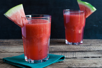 Healthy watermelon smoothie on a wood background