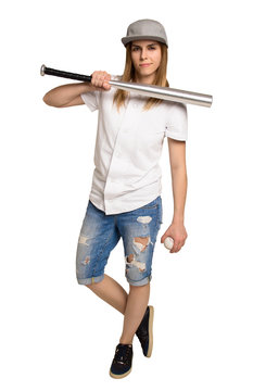 Fashion athletic woman with a baseball bat. The girl in the torn denim shorts and a baseball cap. Copy space. Baseball uniforms. Girl threatened with a baseball bat