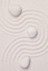 Fototapeta na wymiar Zen garden with white marble rocks and wave pattern in the white
