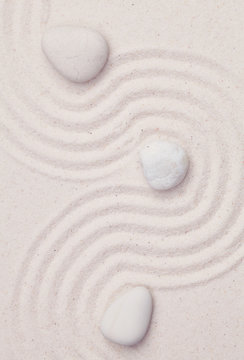 Zen garden with white marble rocks and wave pattern in the white