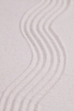 Zen garden with  wave pattern in the white sand