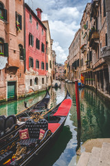 Fototapeta na wymiar Canal, gondolas and houses in Venice