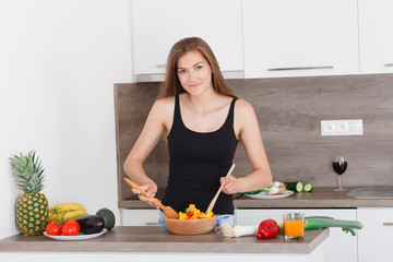 beautiful young girl preparing a healthy dinner