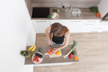 beautiful young girl preparing a healthy dinner