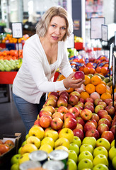 Female pensioner buying fresh fruits