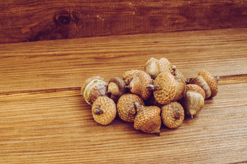 Some acorns on the wooden table