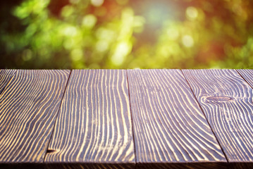 Wooden deck table over beautiful bokeh background