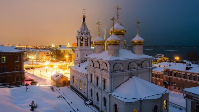Aerial view of Church of the Nativity of John the Precursor in Nizhny Novgorod, Russia at night in winter. Snow and colorful sunset sky. Time-lapse