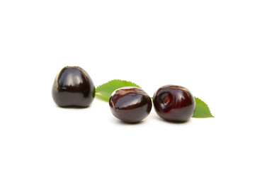 Sweet ripe cherries with leaf isolated on white background