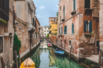 Fototapeta na wymiar Canal, boat and houses in Venice