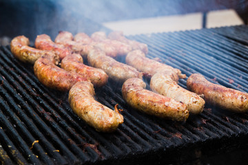 BBQ with fiery sausages on the grill