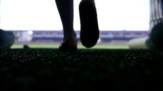 Silhouette of a football player going out to the stadium, slow motion