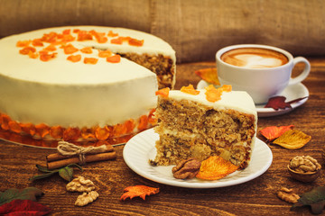 Carrot cake with cappuccino on wooden background